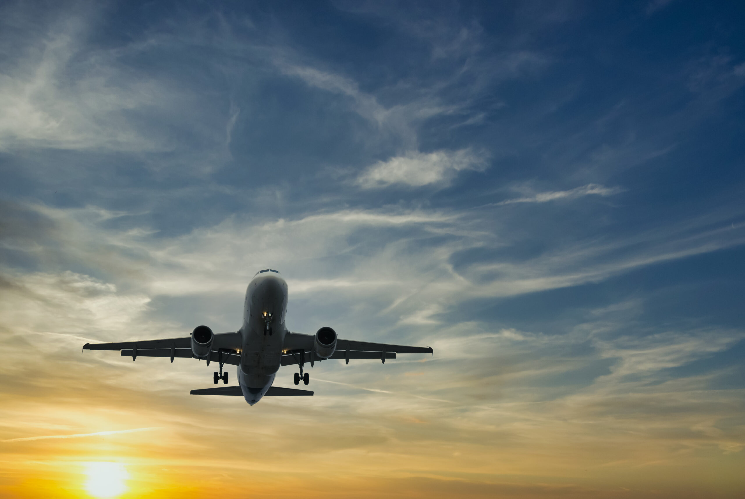 The,Plane,Against,The,Blue,Sunset,Sky.,The,Setting,Sun. Aviation